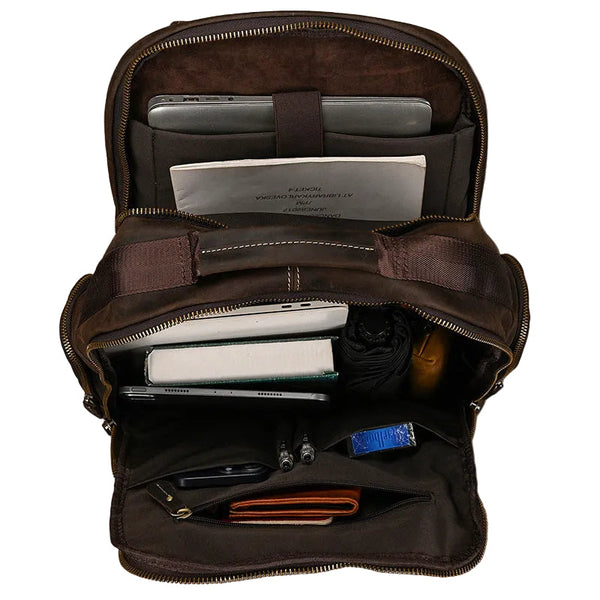 An open brown leather bag seen from above, showing the single main compartment and interior organisation