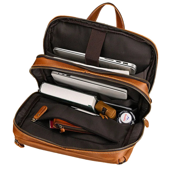 An open brown leather briefcase with a laptop in the padded compartment