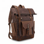 Waxed canvas rucksack showing buckled flap closure and front strap pocket