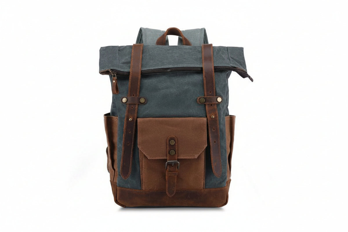Riveted leather grab handle detail on waxed canvas backpack