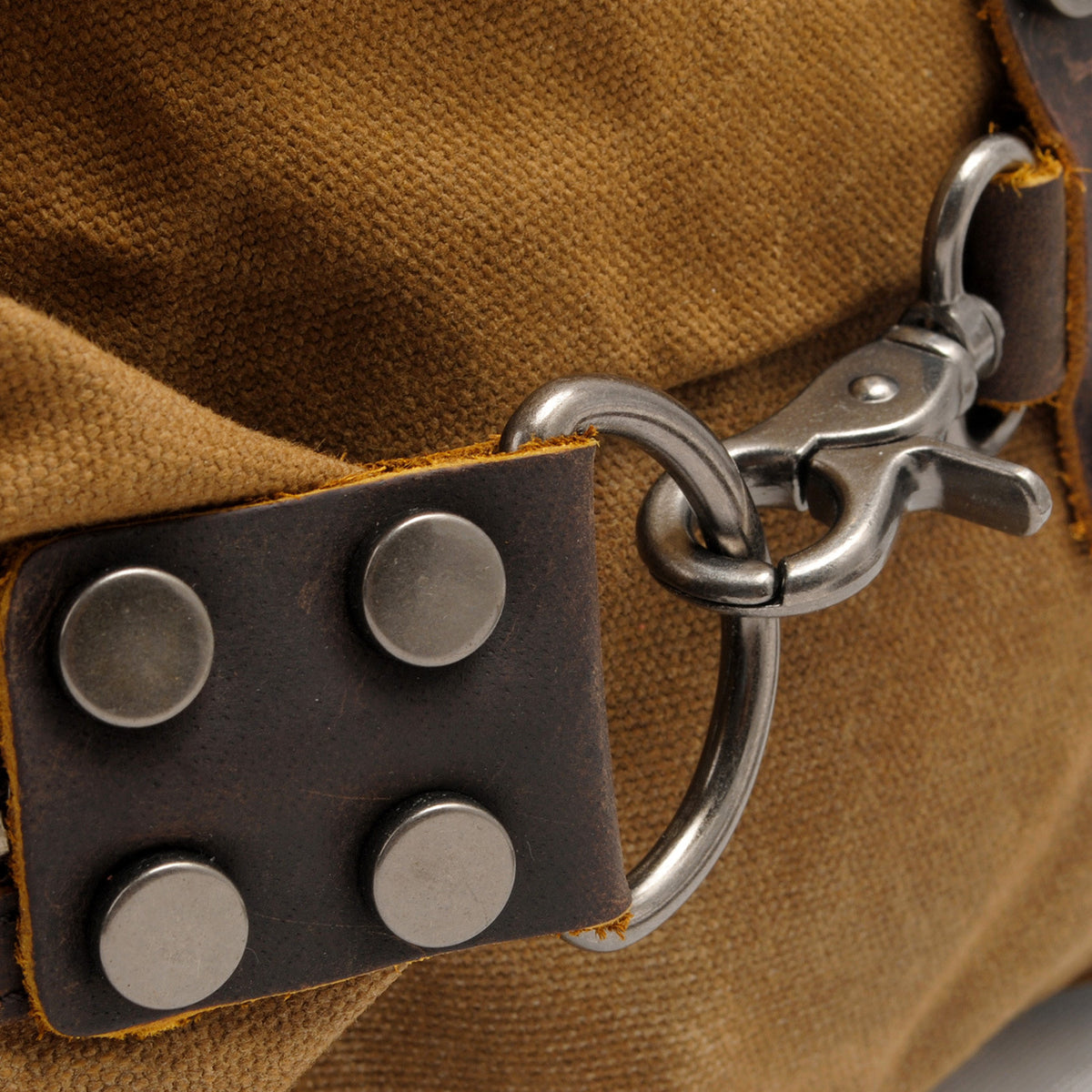 Adjustable crossbody strap on waxed canvas carryall