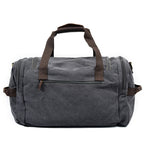 Canvas holdall showing full-length zip and leather-wrapped handles