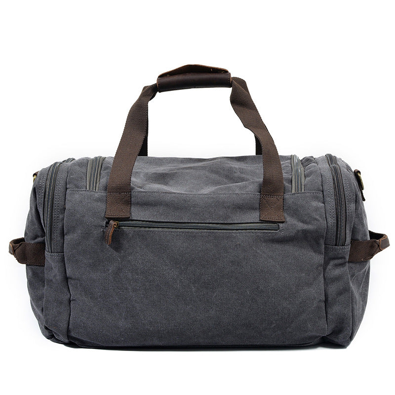 Canvas holdall showing full-length zip and leather-wrapped handles