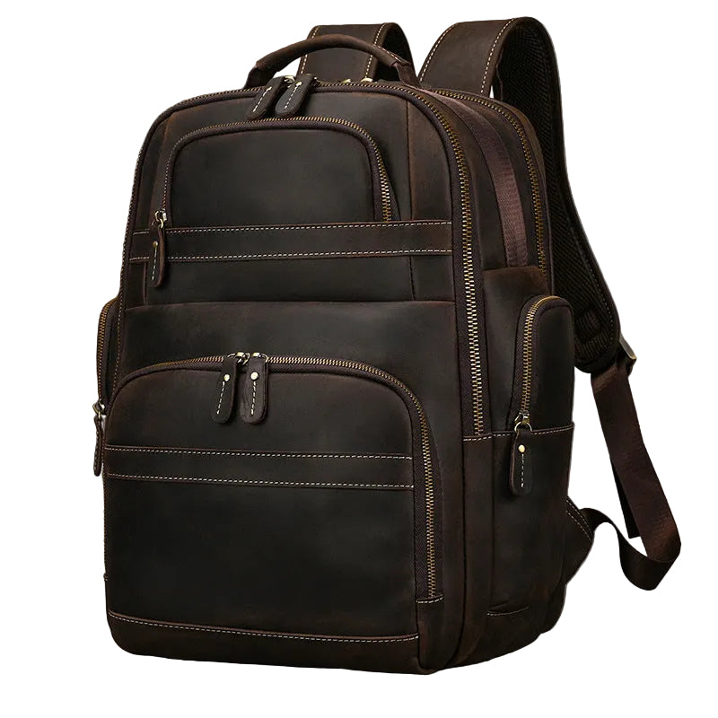 A dark brown leather backpack with multiple zippered compartments and contrast stitching, photographed against a neutral gray textured background.