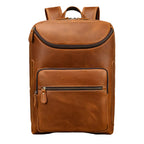 Brown leather backpack on a gray background