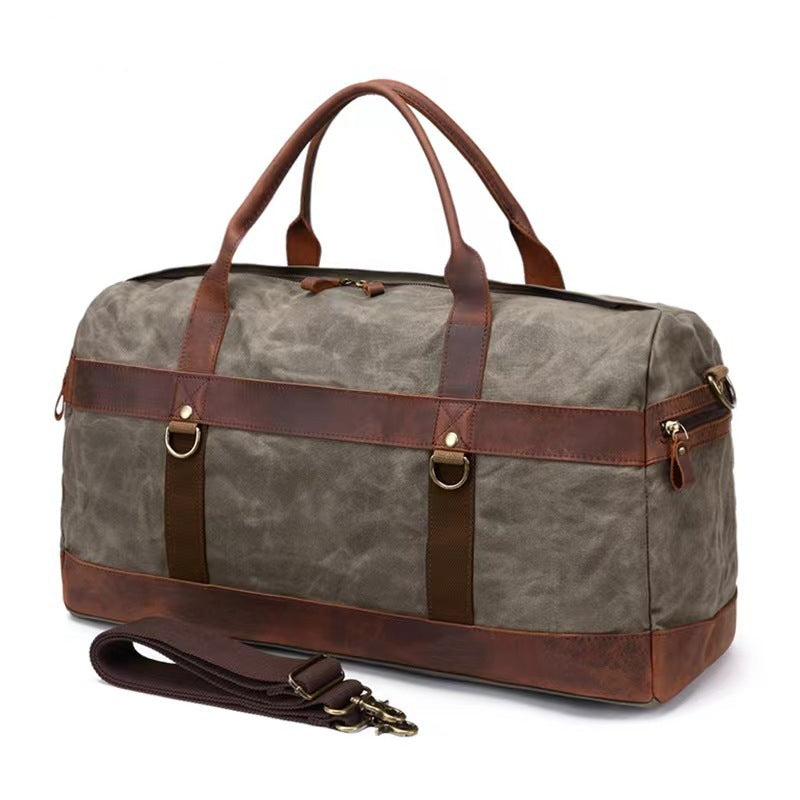 Black canvas sports duffel with leather corner reinforcements