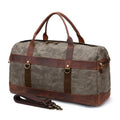 Black canvas sports duffel with leather corner reinforcements