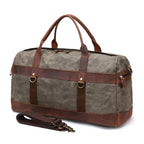 Black canvas sports duffel with leather corner reinforcements