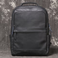 Interior of leather backpack showing padded laptop sleeve and slip pockets