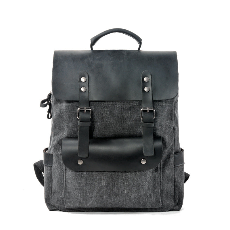 Black cotton canvas college backpack with crazy horse leather trim, front view