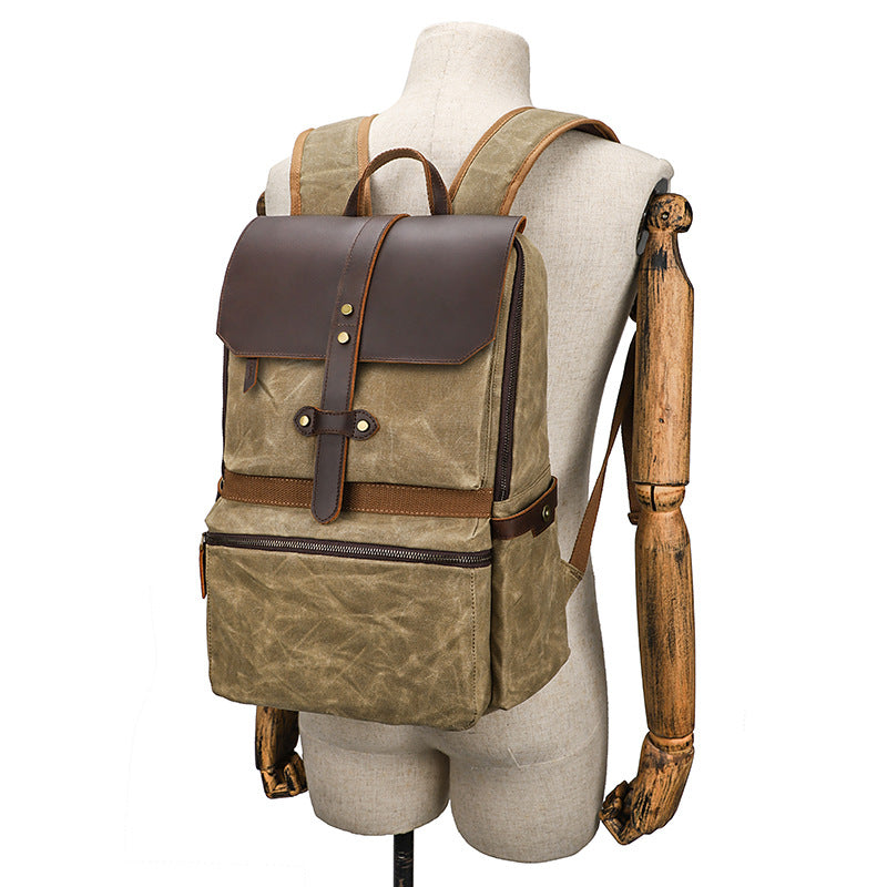 Batik canvas daypack showing zipped front pocket and leather base