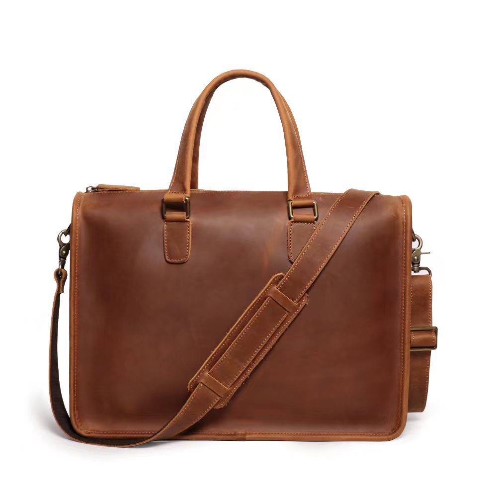 Rear slip pocket and stitching detail on leather laptop bag