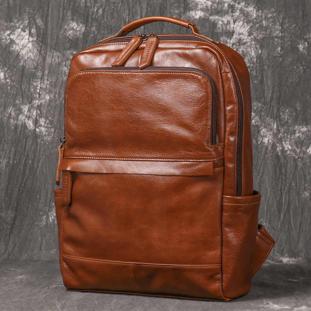 Leather backpack showing wide zip opening to main compartment