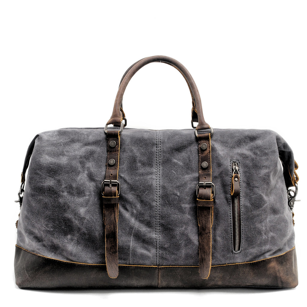 Black oil-wax canvas carryall, three-quarter view