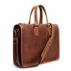 Leather briefcase showing stitched top handle and flap detail