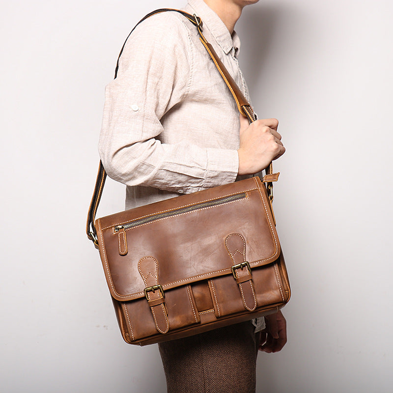 KHAL GOLD Bloomsbury leather A4 satchel worn across the body on the adjustable leather shoulder strap