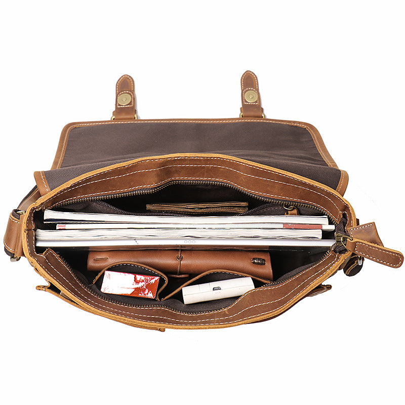 KHAL GOLD Bloomsbury leather A4 satchel open from above, showing A4 documents and a laptop in the main compartment and the front organiser pockets