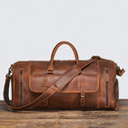 Leather duffle showing two-way full-length zip and rolled handles