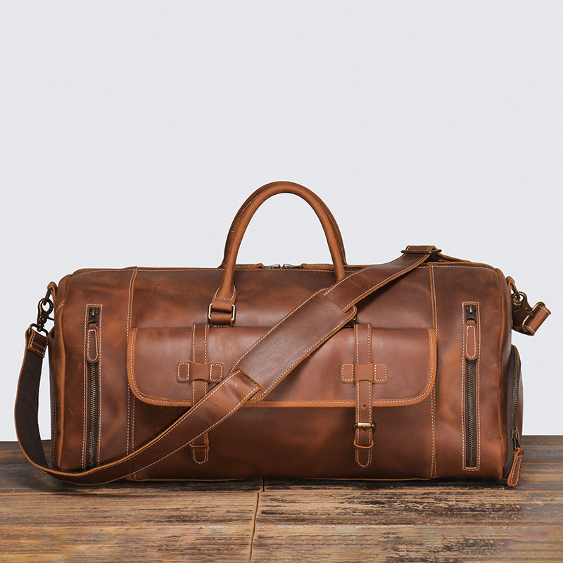 Leather duffle showing two-way full-length zip and rolled handles