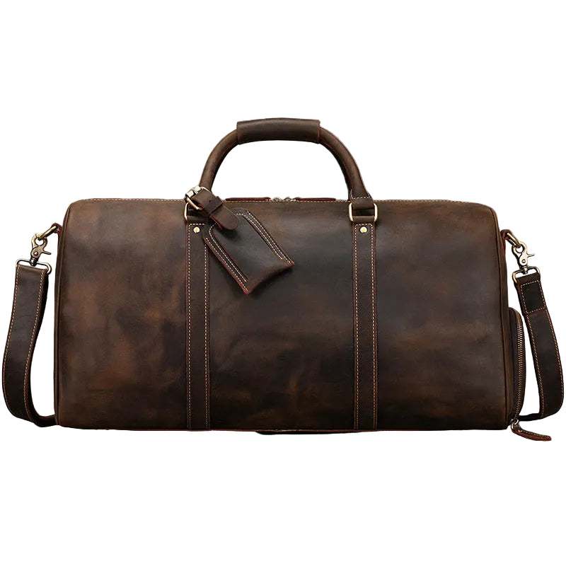 Khal Gold Ambassador weekender in crazy horse brown leather, front view with luggage tag and detachable shoulder strap