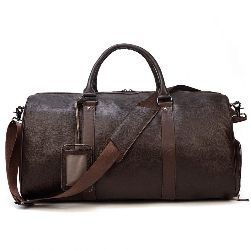 Khal Gold Ambassador weekender in dark brown leather, side view with detachable shoulder strap and luggage tag