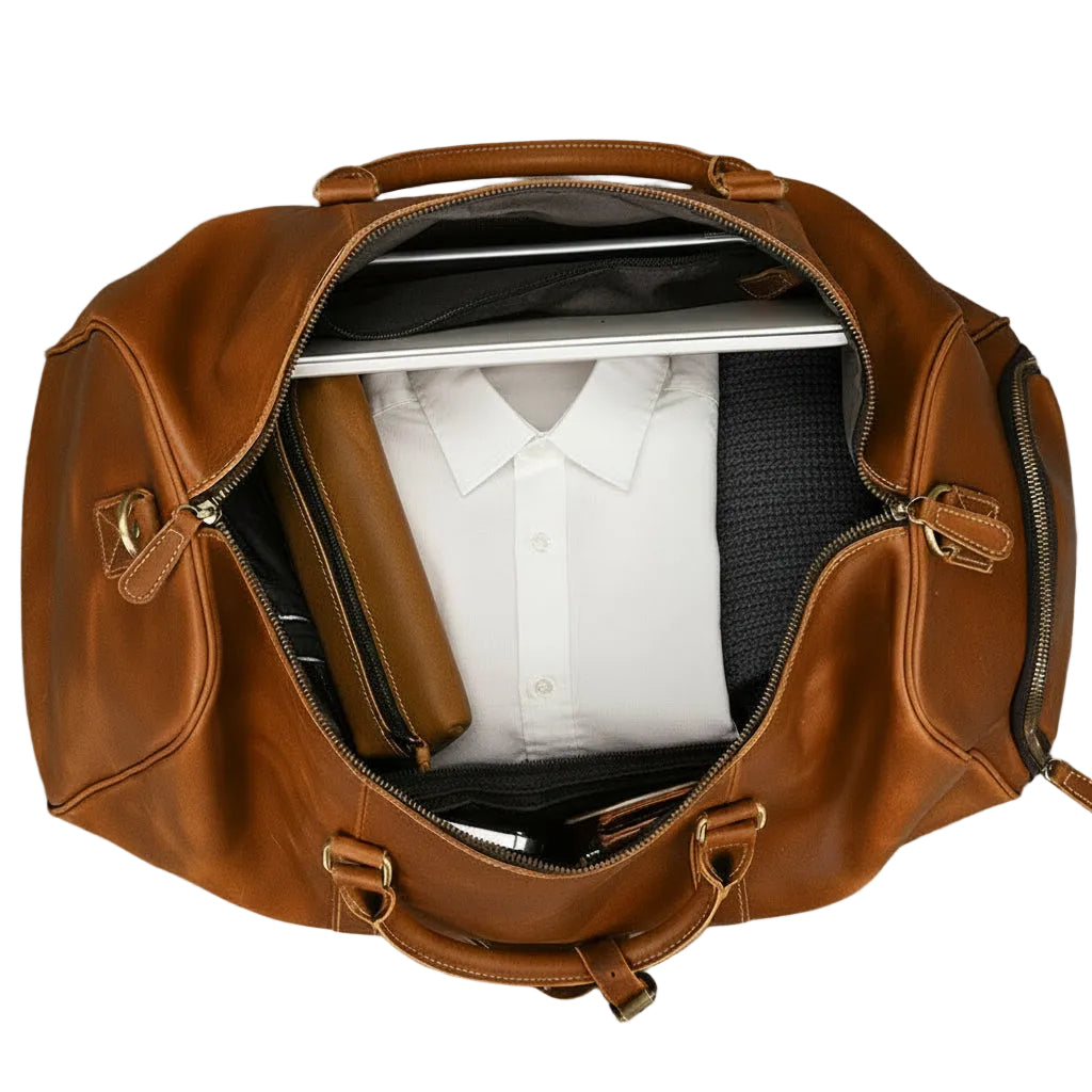 Khal Gold Ambassador weekender seen from above, packed with a folded white shirt, charcoal knitwear, a leather wash bag and a laptop