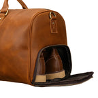 Close-up of the Khal Gold Ambassador weekender's ventilated shoe compartment unzipped with a leather shoe inside