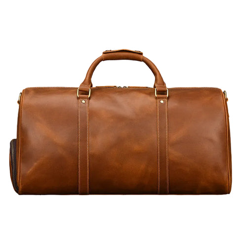 Khal Gold Ambassador weekender in tan crazy horse leather, front view with rolled leather handles and brass hardware