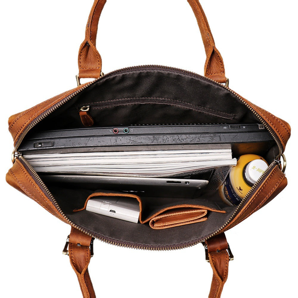 Interior of the Khal Gold Gresham leather briefcase with a laptop, documents and organiser pockets