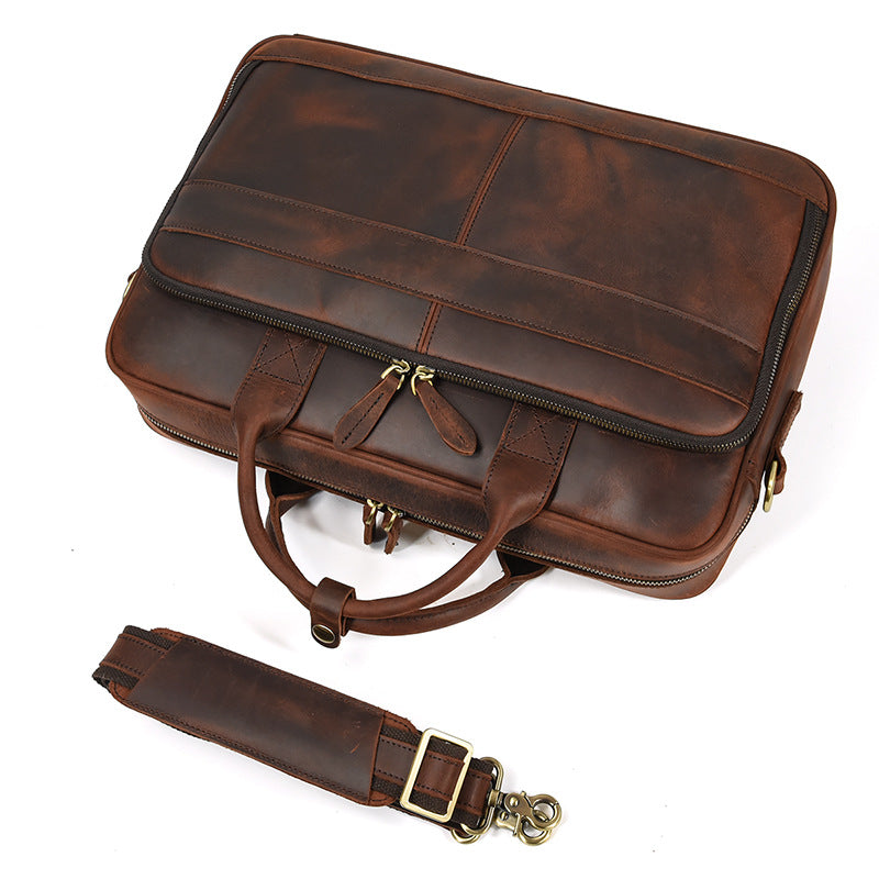 Khal Gold Threadneedle leather briefcase in brown crazy horse leather, top view with the detachable padded shoulder strap alongside