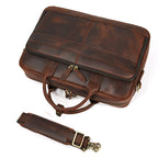 Khal Gold Threadneedle leather briefcase in brown crazy horse leather, top view with the detachable padded shoulder strap alongside