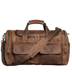 Khal Gold Windsor leather holdall in retro brown crazy horse leather, front view with buckled end pockets and detachable shoulder strap