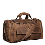 Khal Gold Windsor leather holdall in retro brown crazy horse leather, three-quarter view showing the buckled end pocket and squared base