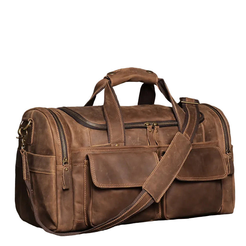 Khal Gold Windsor leather holdall in retro brown crazy horse leather, three-quarter view showing the buckled end pocket and squared base
